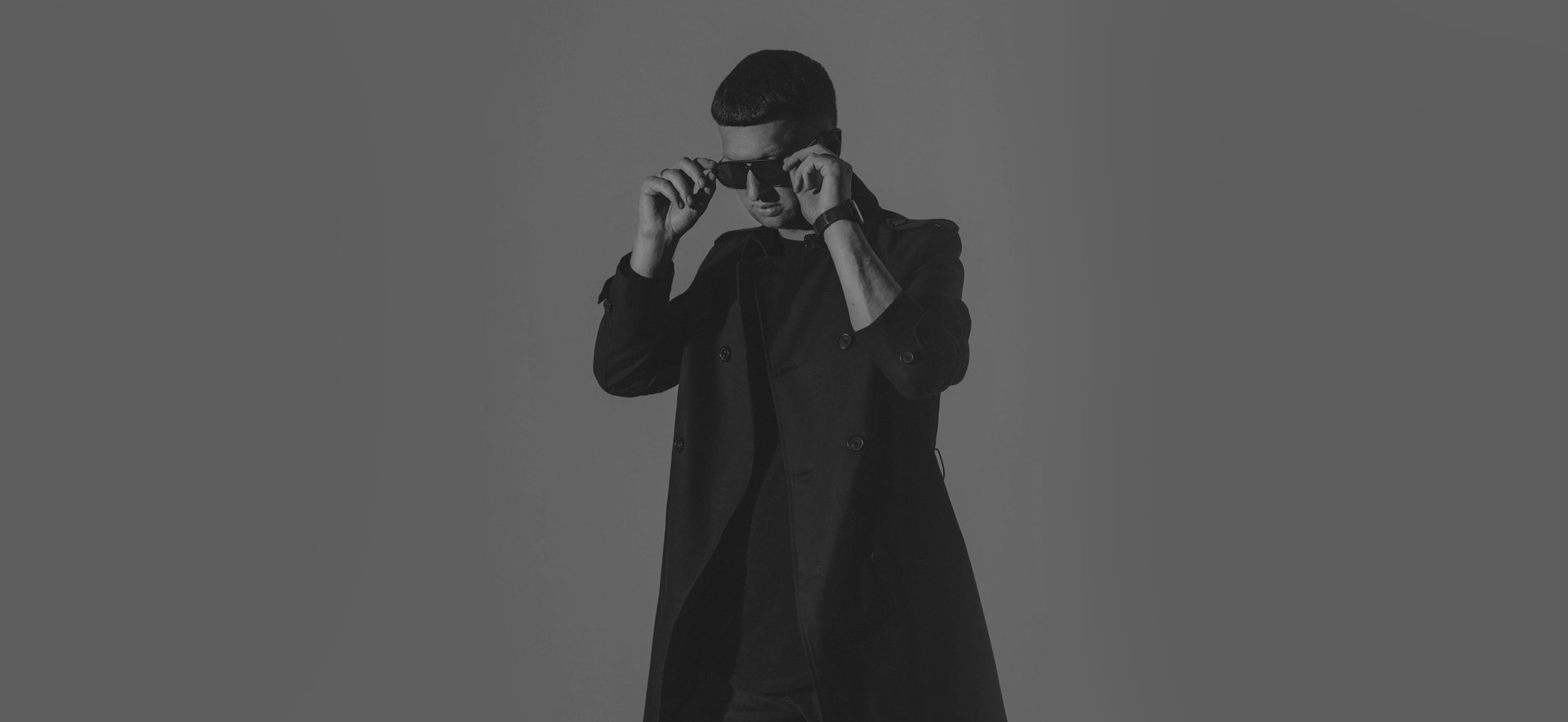 Arnas D in a dark coat and sunglasses