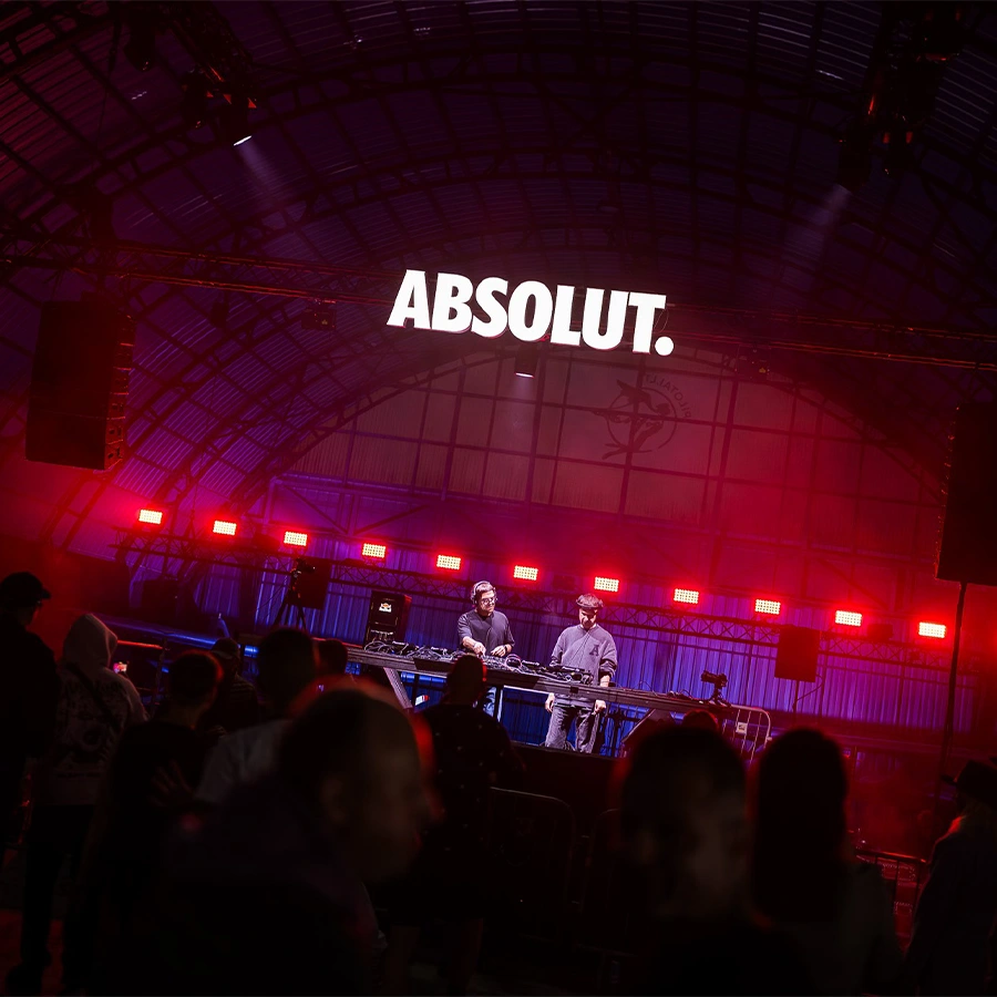 Arnas D and Deividas Bagdanov performing beneath the illuminated Airplane Hangar roof
