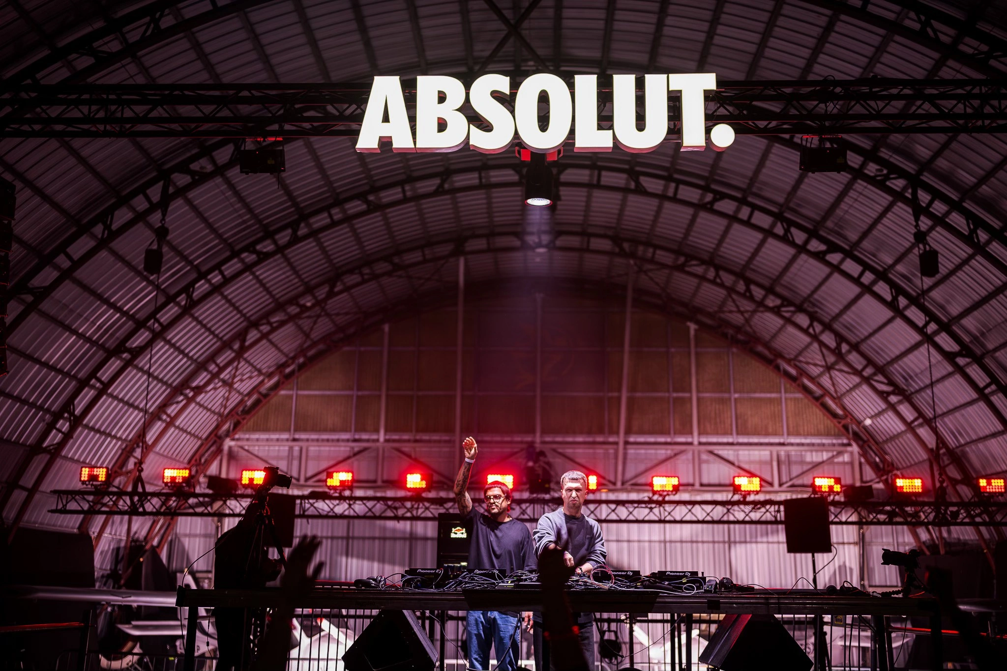 The crowd beneath the airplane hangar roof