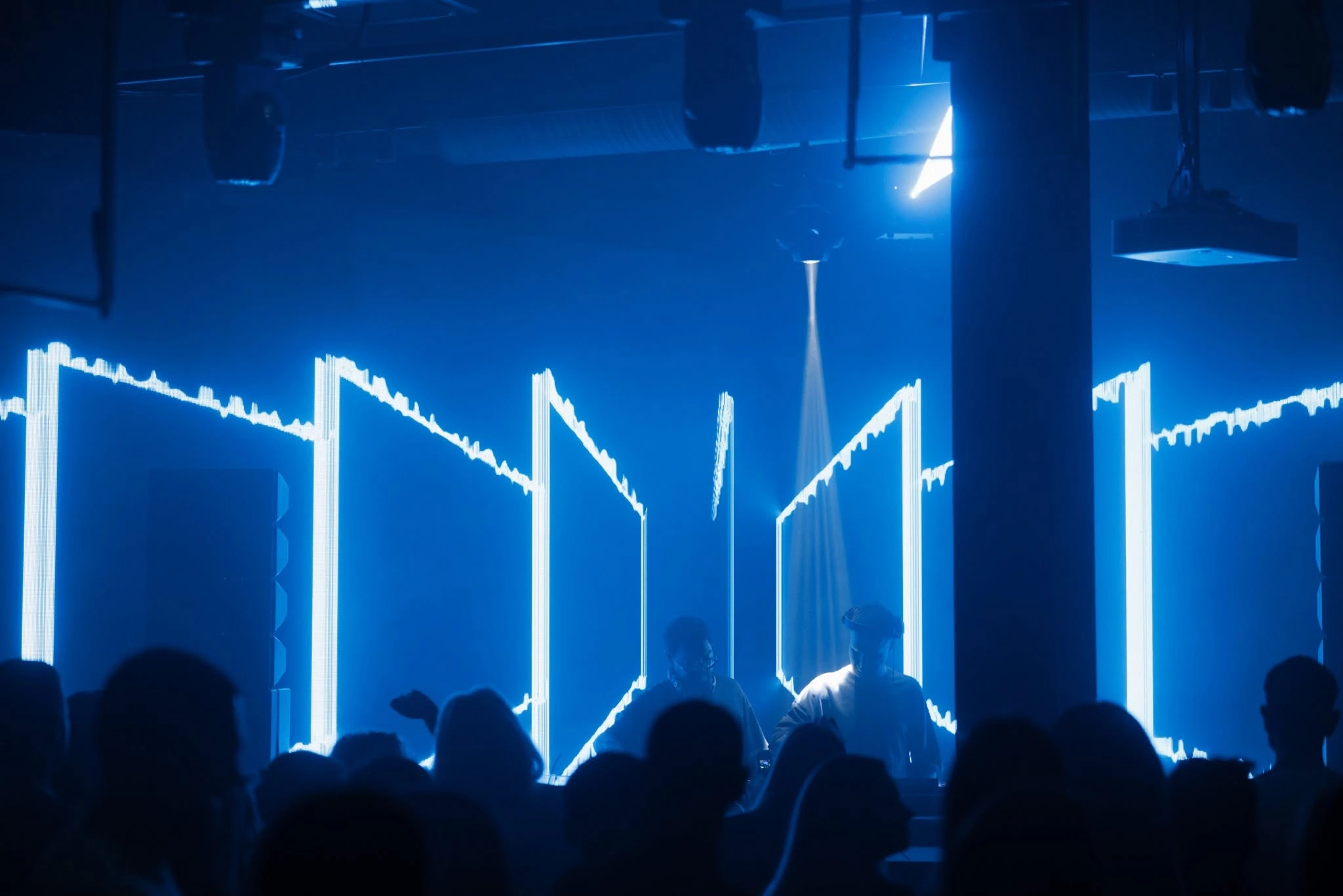 Blue stage lighting above the dance floor