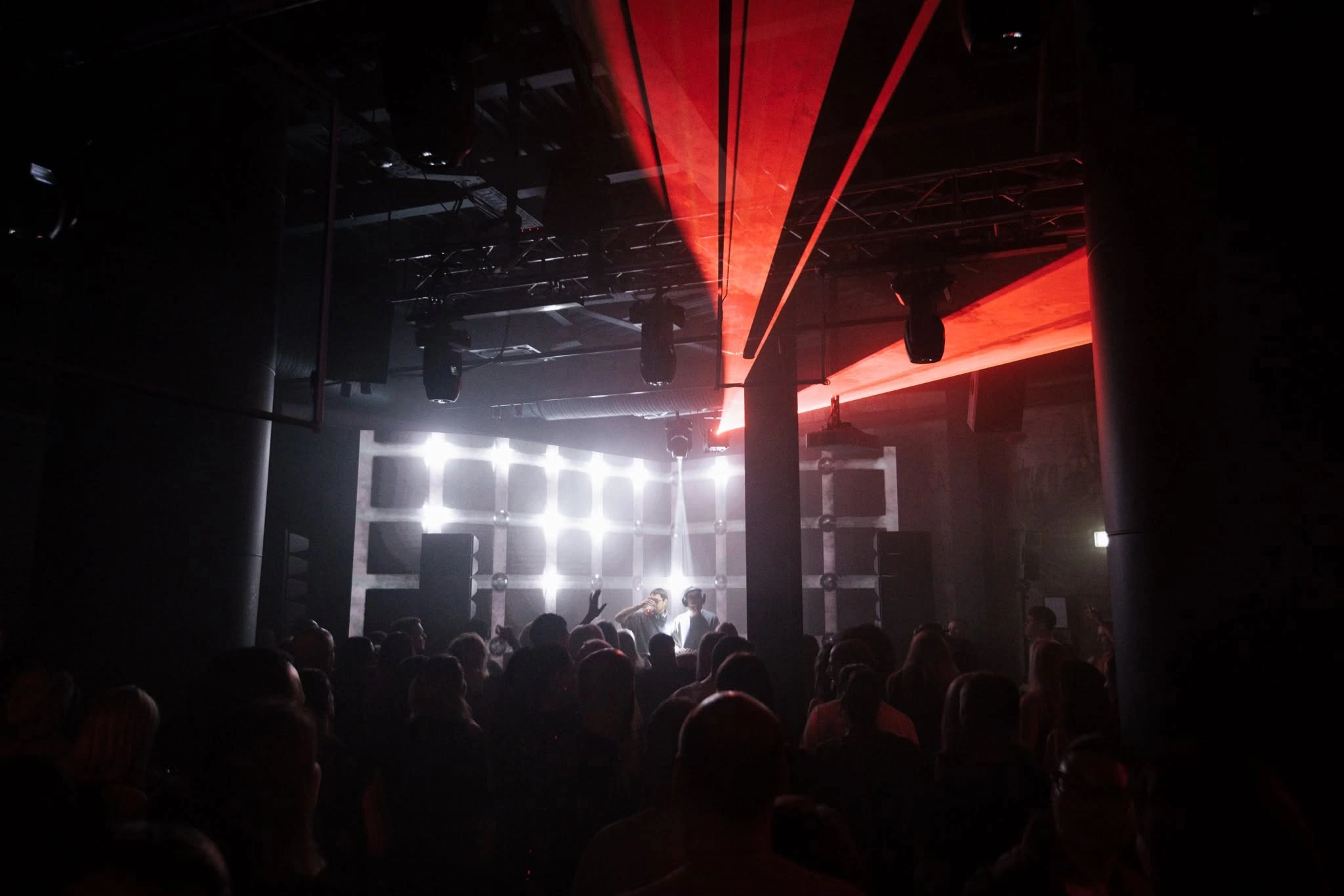 The crowd facing bright lights and red lasers