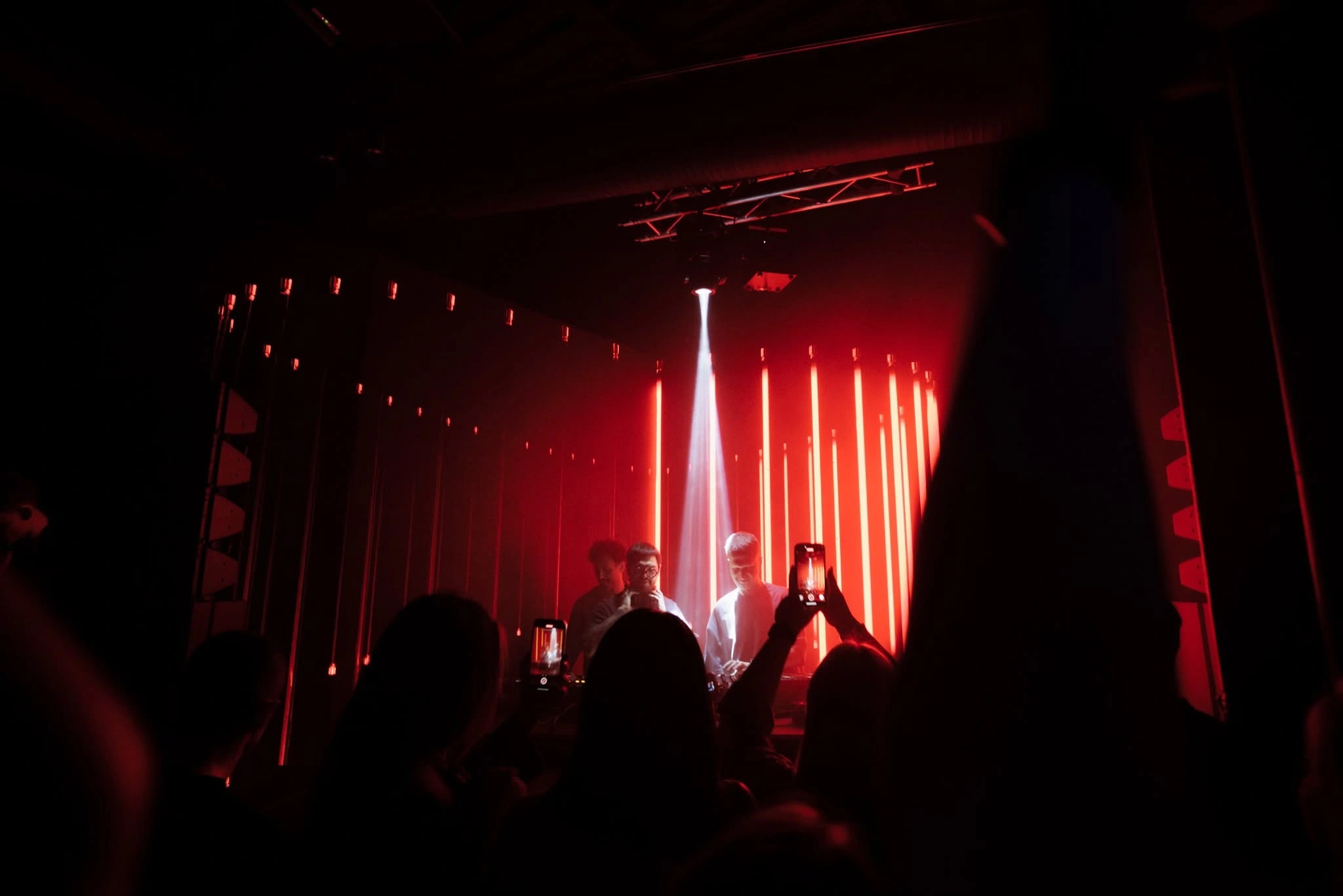 Silhouettes in front of red stage lights